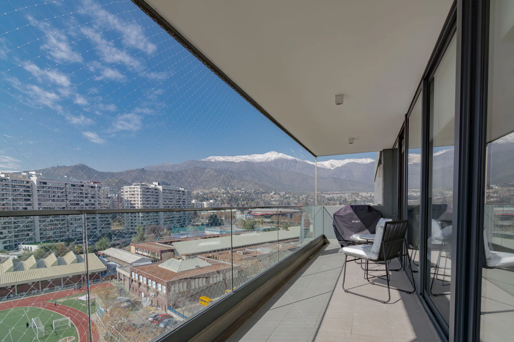 Balcony with discreet safety netting and city view