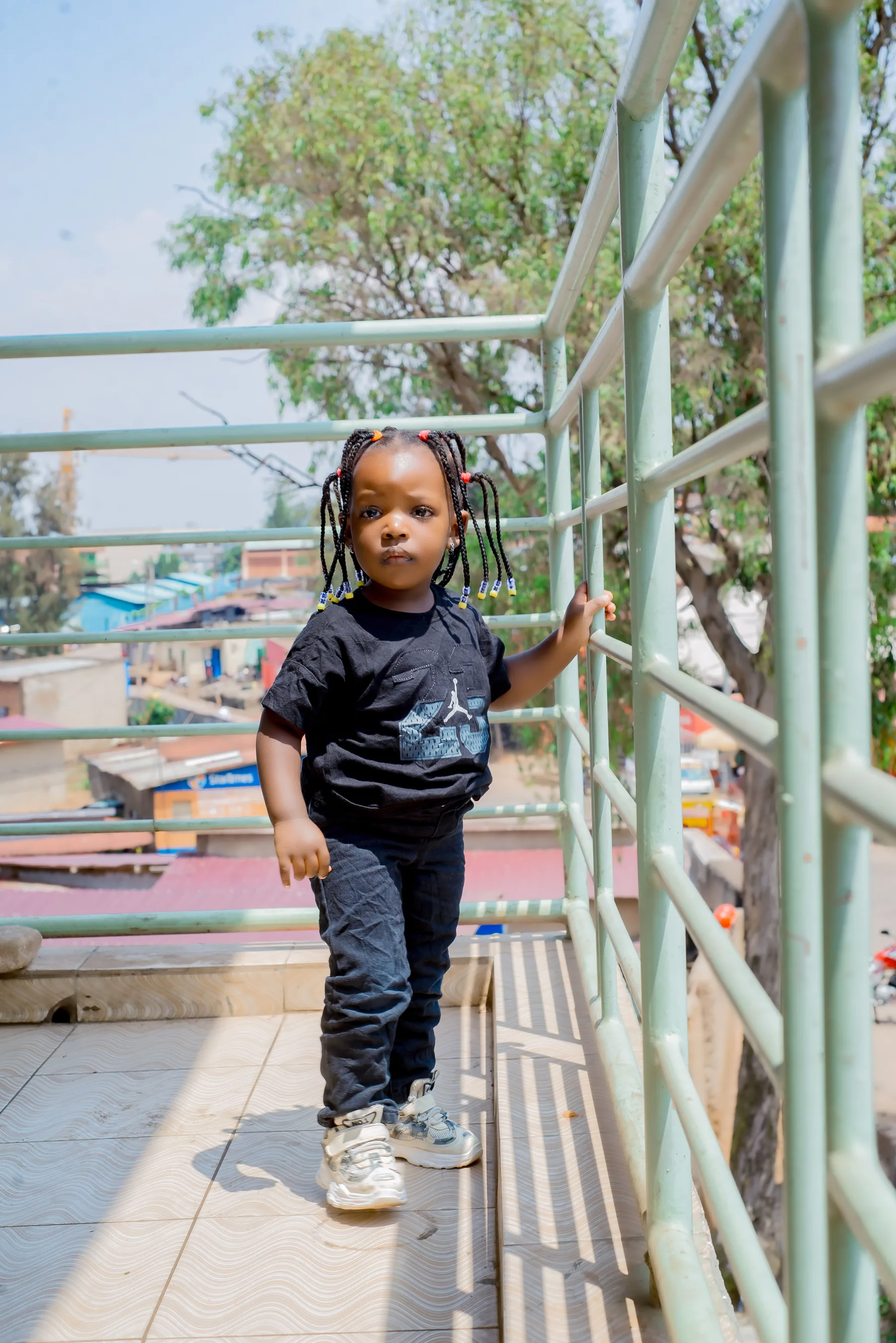 Young child standing on a residential balcony